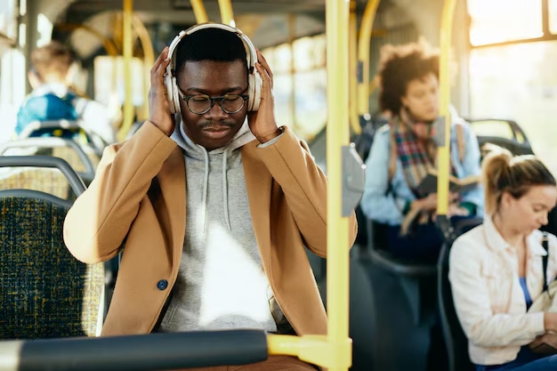 young black man listening music headphones while commuting by bus_637285 12160